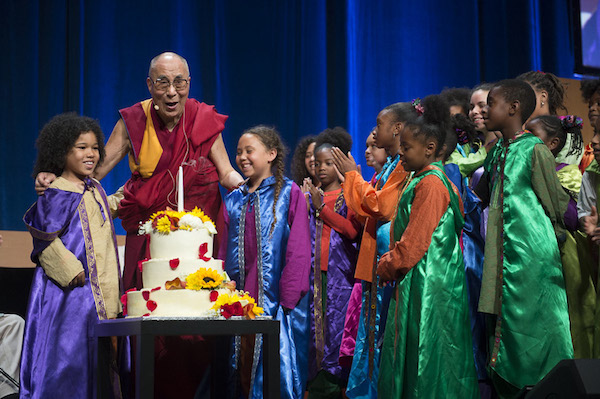 His Holiness the Dalai Lama with children of the Agape Choir after blowing out candles on a cake presented on his 80th birthday during the Global Compassion Summit at the the University of California Irvine in Irvine, California on July 6, 2015. Photo/Tenzin Choejor/OHHDL