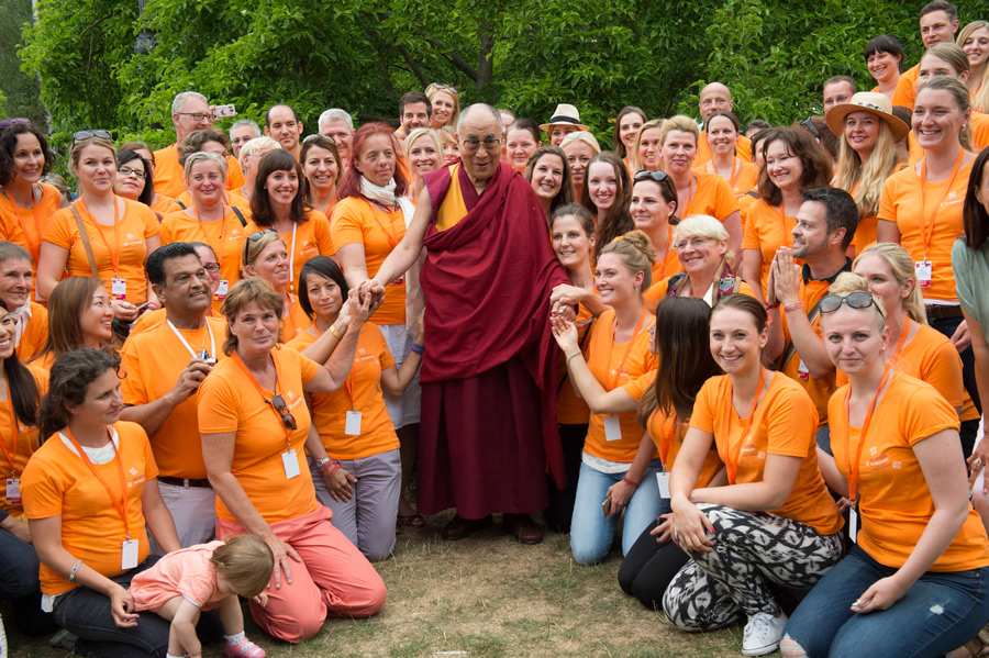 His Holiness the Dalai Lama posing for a photo with volunteers after his talk at Wiesbaden Kupark in Wiesbaden, Hessen, Germany on July 12, 2015. Photo/Manuel Bauer