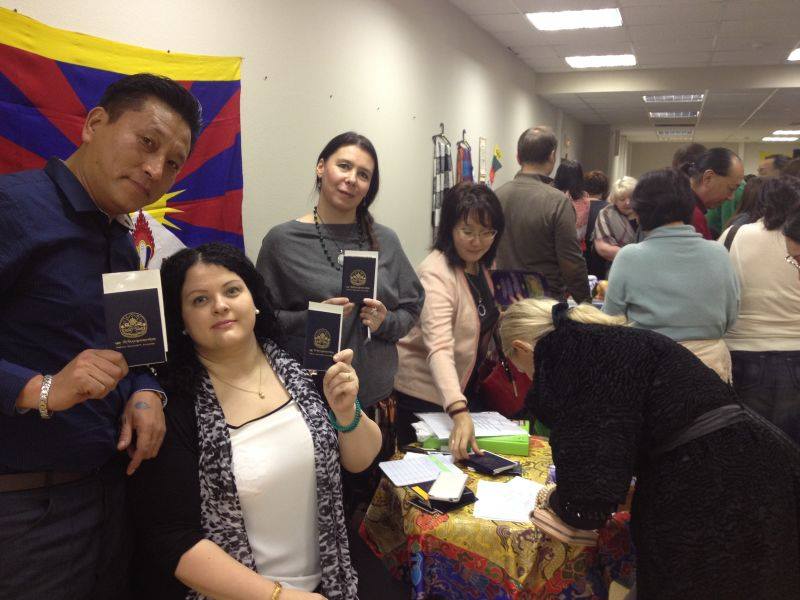 Tibet supporters from Russia displaying their blue book to express their solidarity with Tibet.
