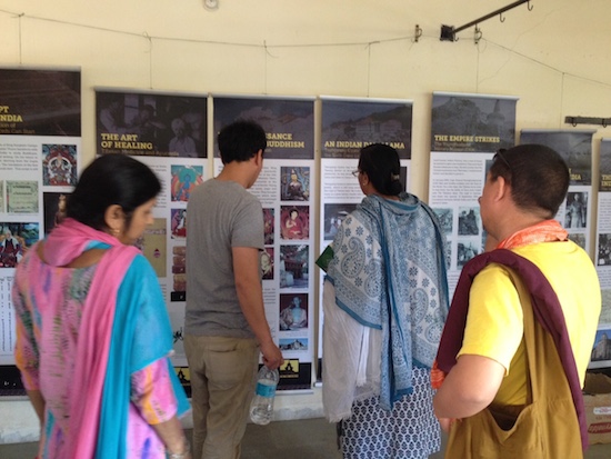 Tibet Museum staff explaining the exhibit to visitors at Indore.
