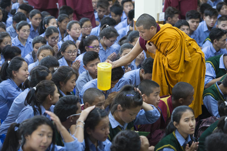Students in the audience receiving ritual water as part of His Holiness the Dalai Lama's bestowing of the Manjushri Permission on the final day of teachings for young Tibetans at the Main Tibetan Temple in Dharamsala, HP, India on June 3, 2016. Photo/Tenzin Choejor/OHHDL