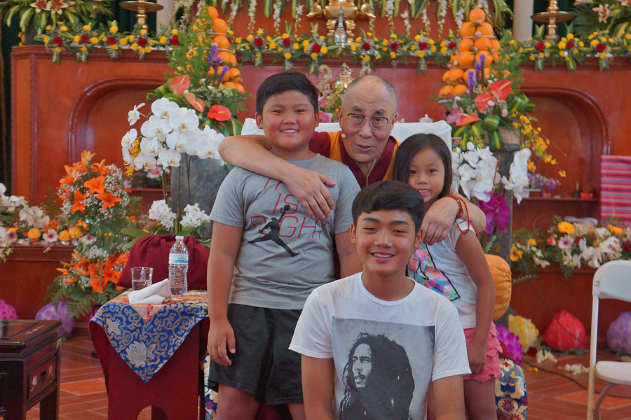 His Holiness the Dalai Lama with three young children at the conclusion of an interactive session with Vietnamese youth as part of the Opening Ceremonies of the Vietnamese Dieu Ngu Buddhist Temple in Westminster, California on June 19, 2016. Photo/Jeremy Russell/OHHDL