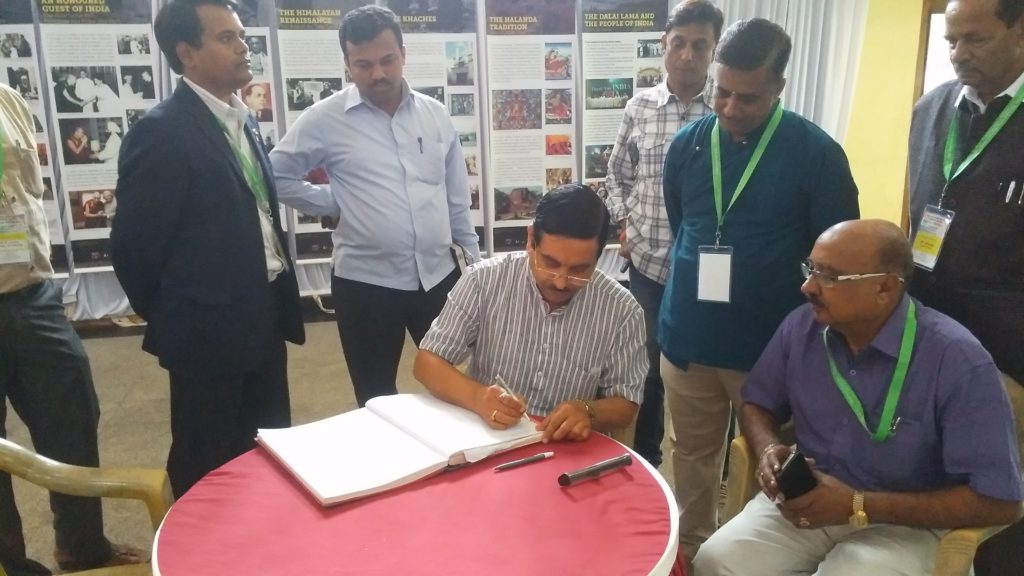 Shri Pralhad Joshi, Lok Sabha MP from Dharwad, the Chief Guest writing on visitor's comment book.