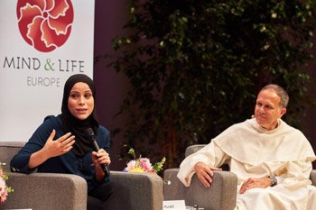 Brother Thierry-Marie Courau looking on as Alaa Murabit speaks at the Mind & Life Dialogue in Brussels, Belgium on September 10, 2016. Photo/Olivier Adam