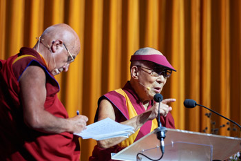French interpreter Ven Matthieu Ricard takes notes during His Holiness the Dalai Lama's talk at the Brussels Expo in Brussels, Belgium on September 11, 2016. Photo/Olivier Adam