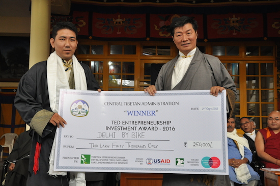 Mr Tenzin Gyalpo, owner of Delhi By Bike, a cycling tour business, receiving the aard from Sikyong Dr Lobsang Sangay, 2 September 2016.
