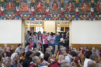 Members of the audience standing in the doorway of the Main Tibetan Temple to catch a glimpse of His Holiness the Dalai Lama during a break in his teachings in Dharamsala, HP, India on October 4, 2016. Photo/Tenzin Choejor/OHHDL