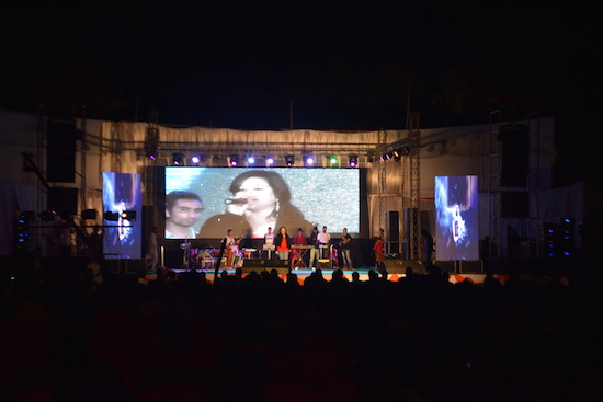 A female singer performing a Bollywood song at the event.