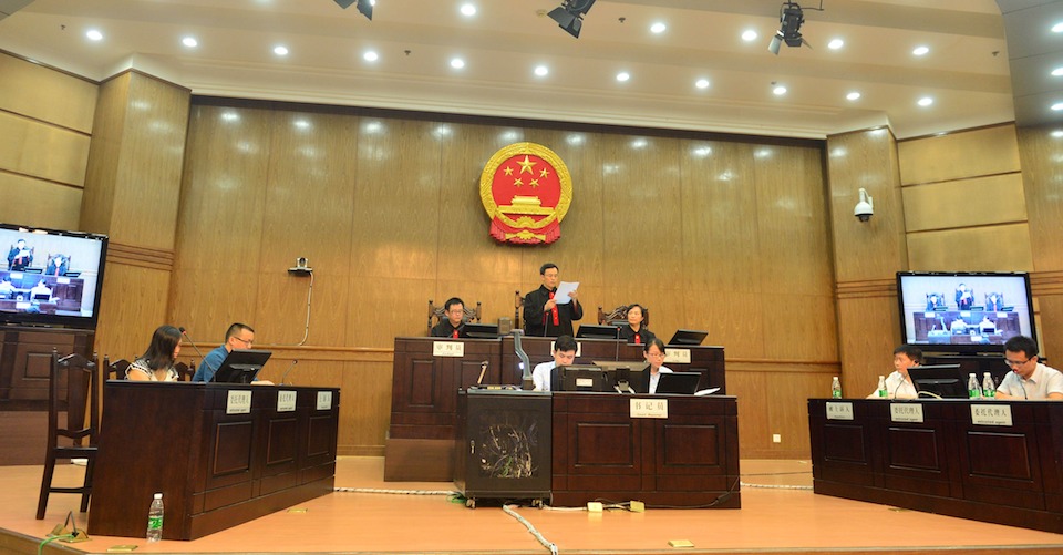 China rape victim's mother Tang Hui (L) sits in the Hunan Provincial People's High Court in Changsha, central China's Hunan province on July 15, 2013.  The court awarded damages to the mother of a rape victim after she was sent to a labour camp for demanding her daughter's attackers be punished, a spokesman said on July 15.   CHINA OUT     AFP PHOTO        (Photo credit should read STR/AFP/Getty Images)