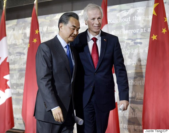 China's Minister of Foreign Affairs Wang Yi (left) and Canada's Minister of Foreign Affairs Stephane Dion leave following a press conference on Wednesday, June 1, 2016 in Ottawa. THE CANADIAN PRESS/Justin Tang