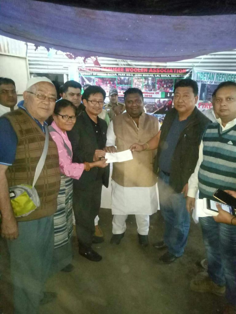 The minister from the Delhi State Government with some of the affected Tibetan shopkeepers.