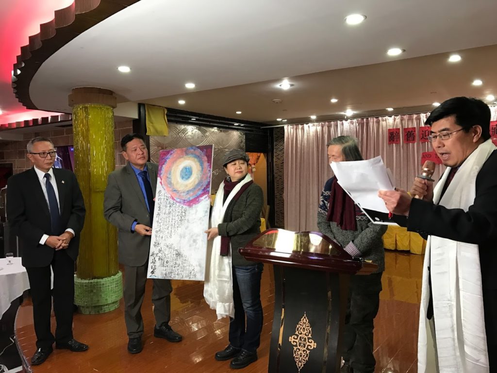 Representative Penpa Tsering being presented a painting with poetry by Hong Xian to symbolise the Chinese people's solidarity with the Tibetan people.