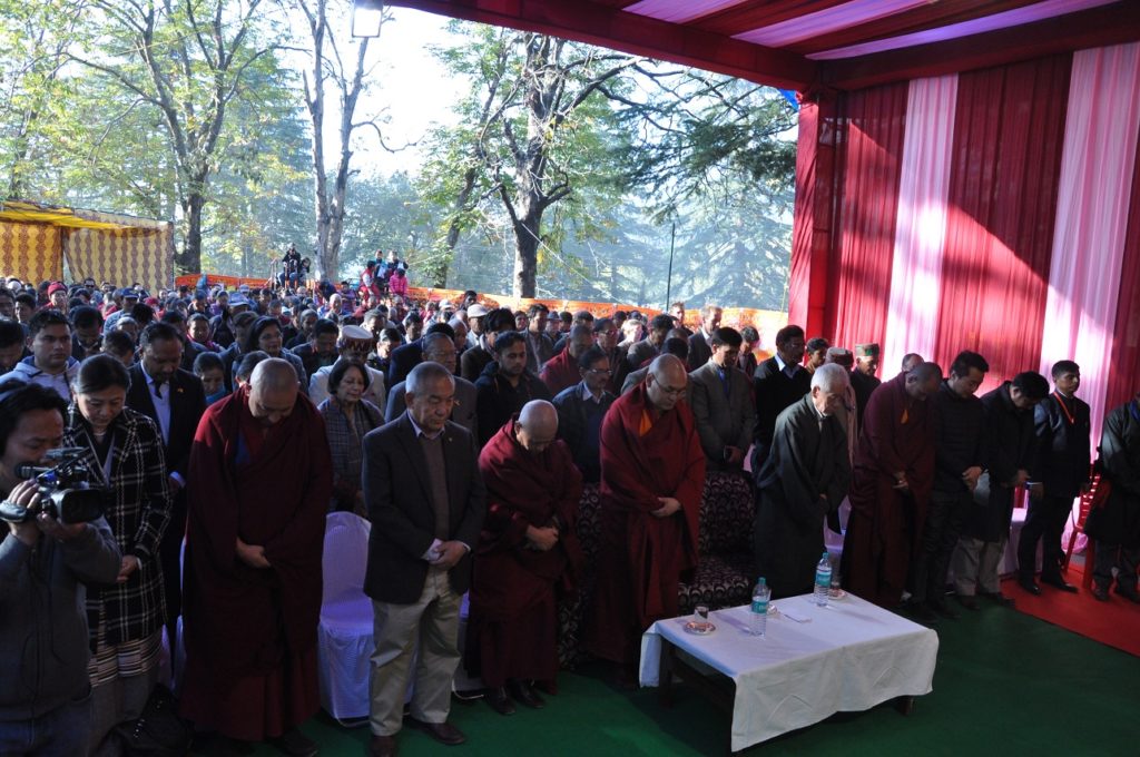 Guests and participants bof the tw0-day festival observing a minute's silence in memory of self-immolater Tahsi Rabten