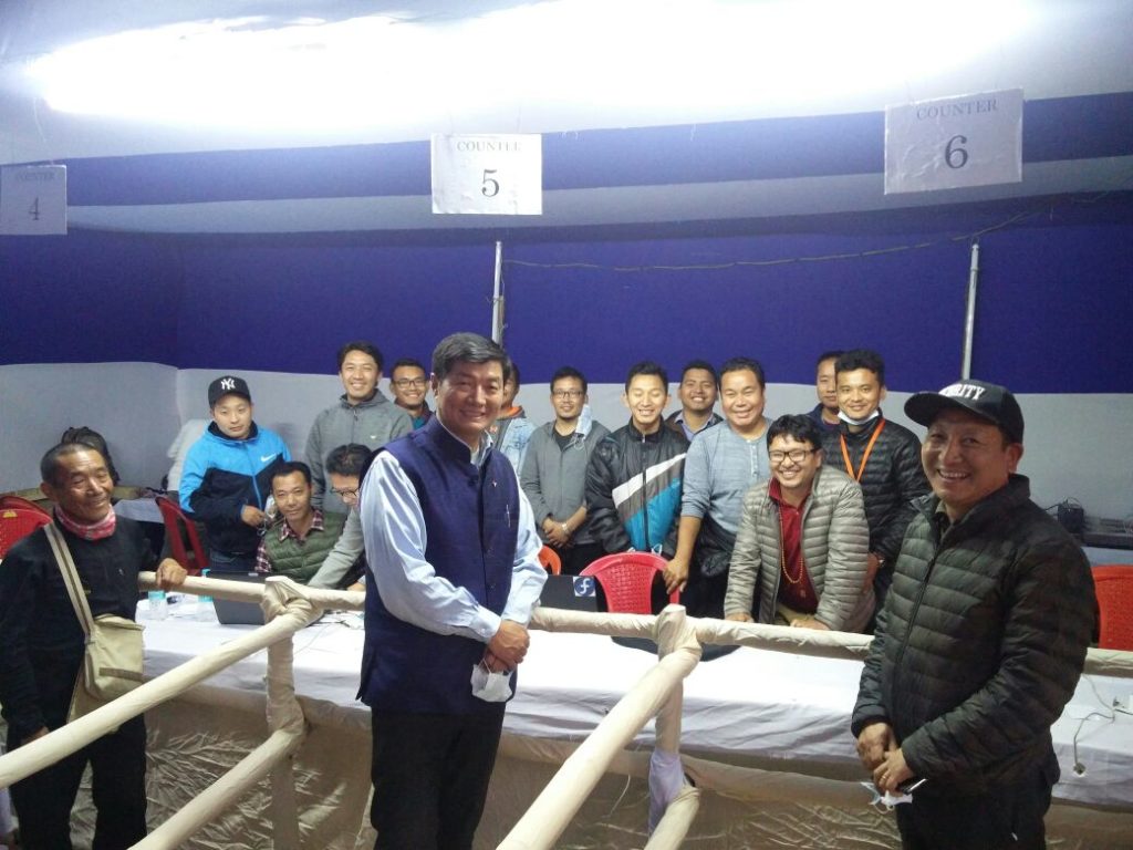 Sikyong posing for a photo with the ground staff.