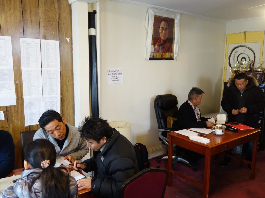 Members of Tibetan community getting in queue to pay Green Book tax. 