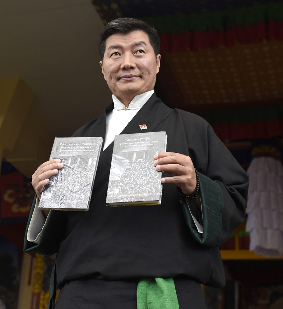 Sikyong releasing the book of His Holiness the Dalai Lama's 10 March statements from 1961 - 2011.