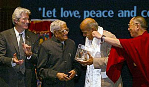 His Holiness the Dalai Lama pulls Shri Rabi Rai's ear at the 'Gere Light of Truth Award for Indians' in New Delhi in December 2002.