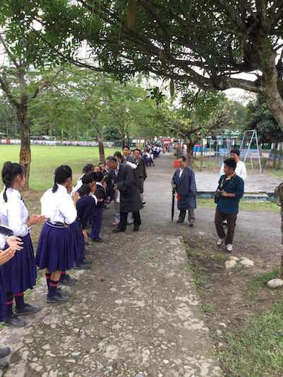 Kalon being welcomed at the school by students.