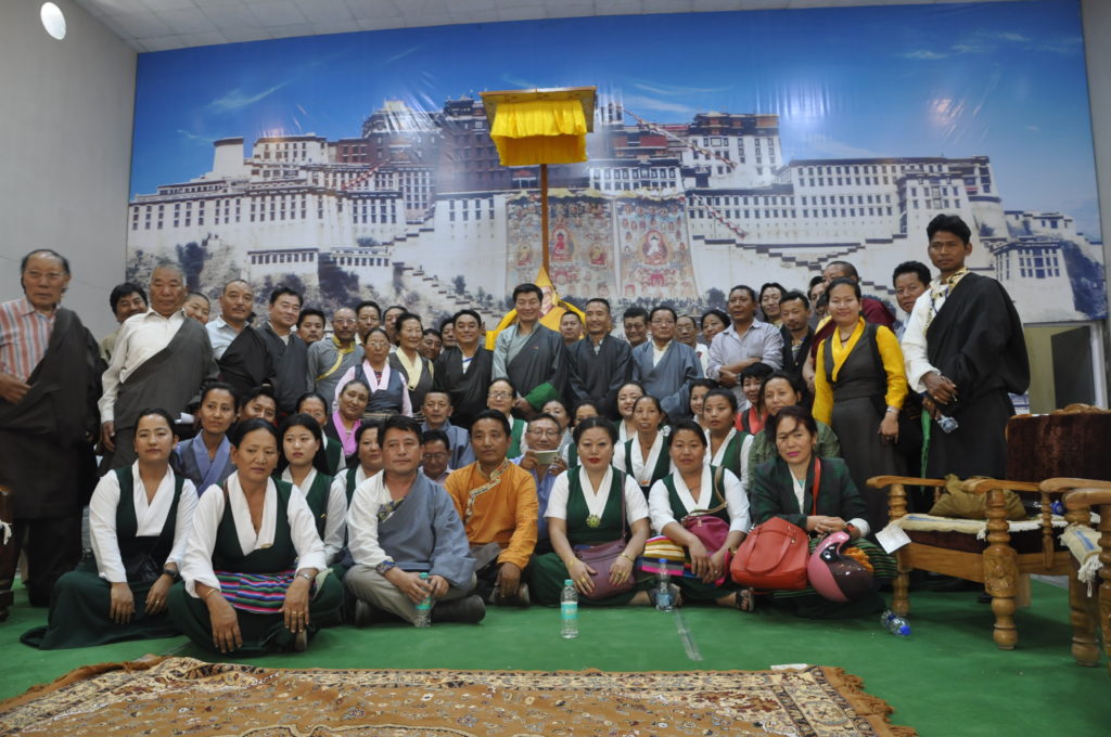 Sikyong posing a goup photo with staff and representatives of NGOs in Dekyiling settlement, 1 April 2017.