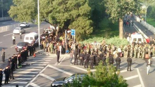 Military veterans from many provinces of China protest outside military headquarters demanding unpaid pensions and benefits, Oct. 11, 2016.