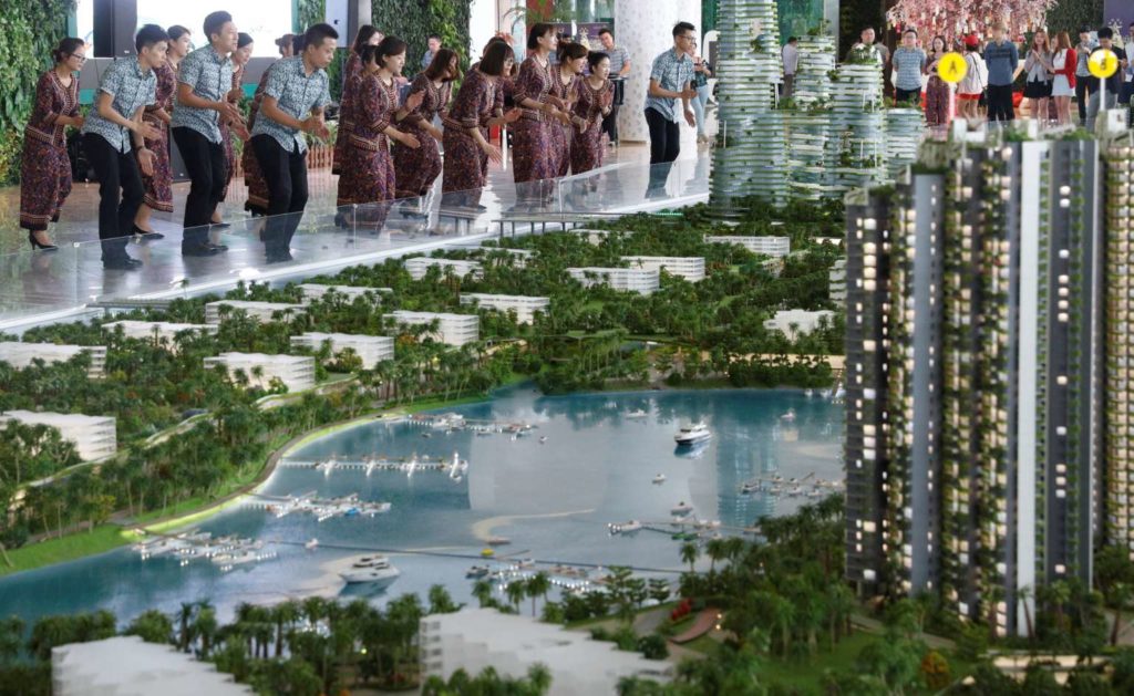 Sales agents, mostly from China, dressed in traditional Malaysian batik and entertaining visitors at Chinese property developer Country Garden's Forest City showroom in Johor Baru in February this year. China is now the largest investor in Malaysia, but a survey found that only 13 per cent of respondents feel that this will benefit ordinary Malaysians. PHOTO: REUTERS