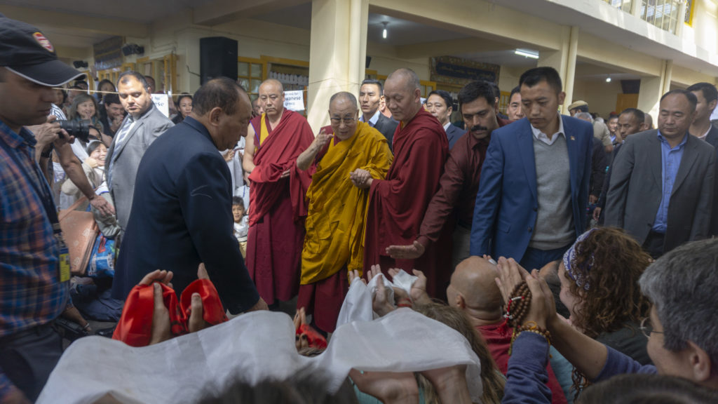 His Holiness bidding goodbye to the devotees as he proceeds towards his residence. Photo/Tenzin Jigme/CTA