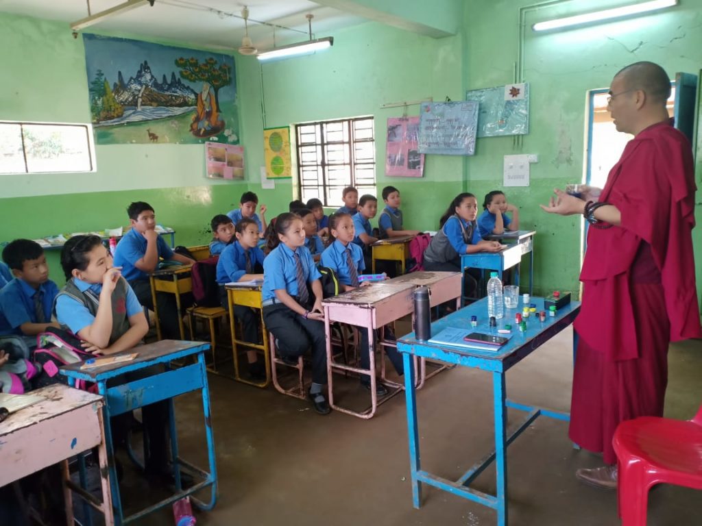 DOE mentor speaking to younger school children from the Tibetan schools in South India.