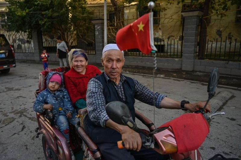 A man drives in an ethnic Uighur neighborhood in Aksu, Xinjiang on Sept. 11, 2019. HECTOR RETAMAL—AFP/Getty Images