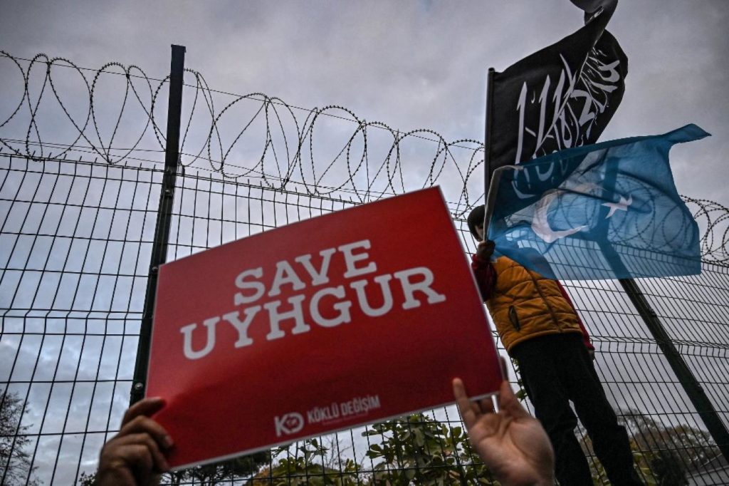 Protesters call on the international community to aid China’s Uighur Muslims outside the Chinese consulate in Istanbul on 13 December (AFP)