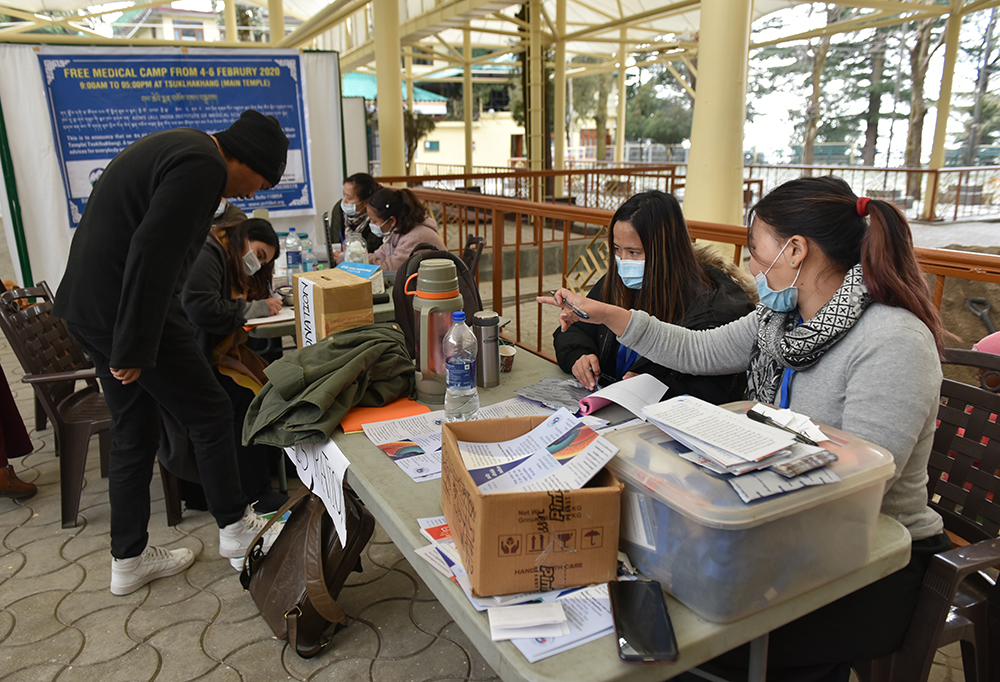 The Department of Health staff and volunteers engaged in the registration of visitors at the free health camp. Photo/ Tenzin Phende/ CTA 