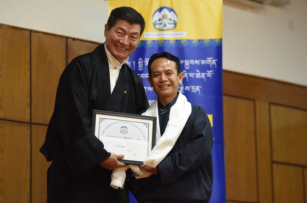 Sikyong Dr. Lobsang Sangay felicitates Mr. Tenzin Choephal of the Department of Health for excellence in service, 6 July 2020.