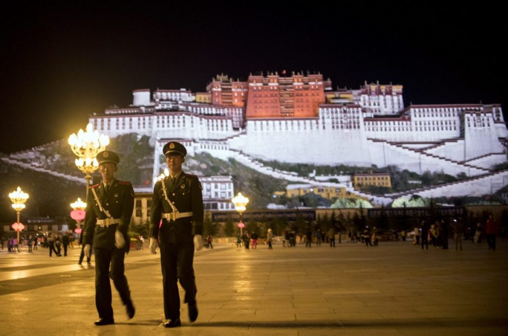 Two Chinese paramilitary policemen patrol near the iconic Potala Palace in Lhasa in China's Tibet Autonomous Region. The US Congress has voted to demand access for US diplomats, journalists and tourists to Tibet. Photo: AFP/Johannes Eisele