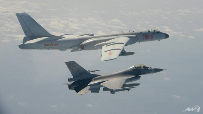 A handout photo taken and released on Feb 10, 2020 by Taiwan's Defence Ministry shows a Taiwanese F-16 fighter jet (bottom) flying next to a Chinese H-6 bomber. (Photo: AFP/Handout)