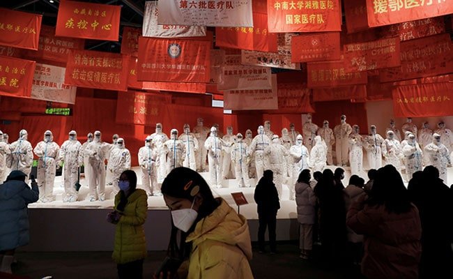 FILE PHOTO: Visitors attend an exhibition on the fight against the coronavirus disease (COVID-19) outbreak, at Wuhan Parlor Convention Center that previously served as a makeshift hospital for COVID-19 patients in Wuhan, Hubei province, China December 31, 2020. REUTERS/Tingshu Wang/File Photo