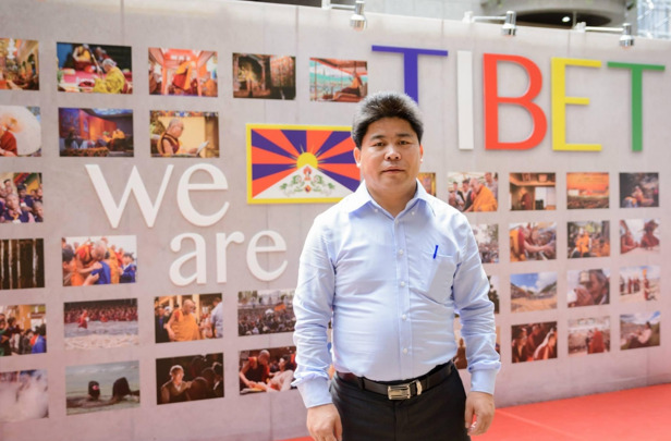 Mr Dawa standing in front of the exhibition on Tibet at Taipei city office hall in 2017. 