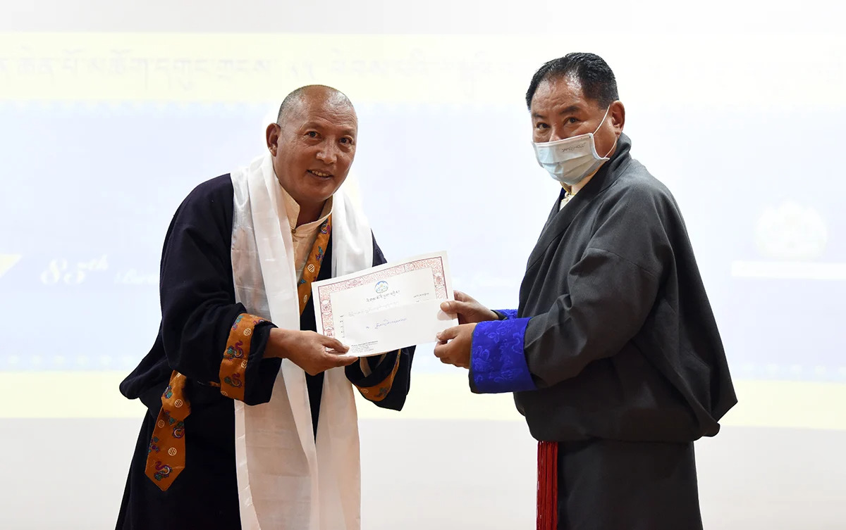 Then Speaker Pema Jungney felicitating CTA staff Mr. Lobsang Tsetan for completing 25 years service at Central Tibetan Administration, 6 July 2020. Photo | Tenzin Phende | CTA 