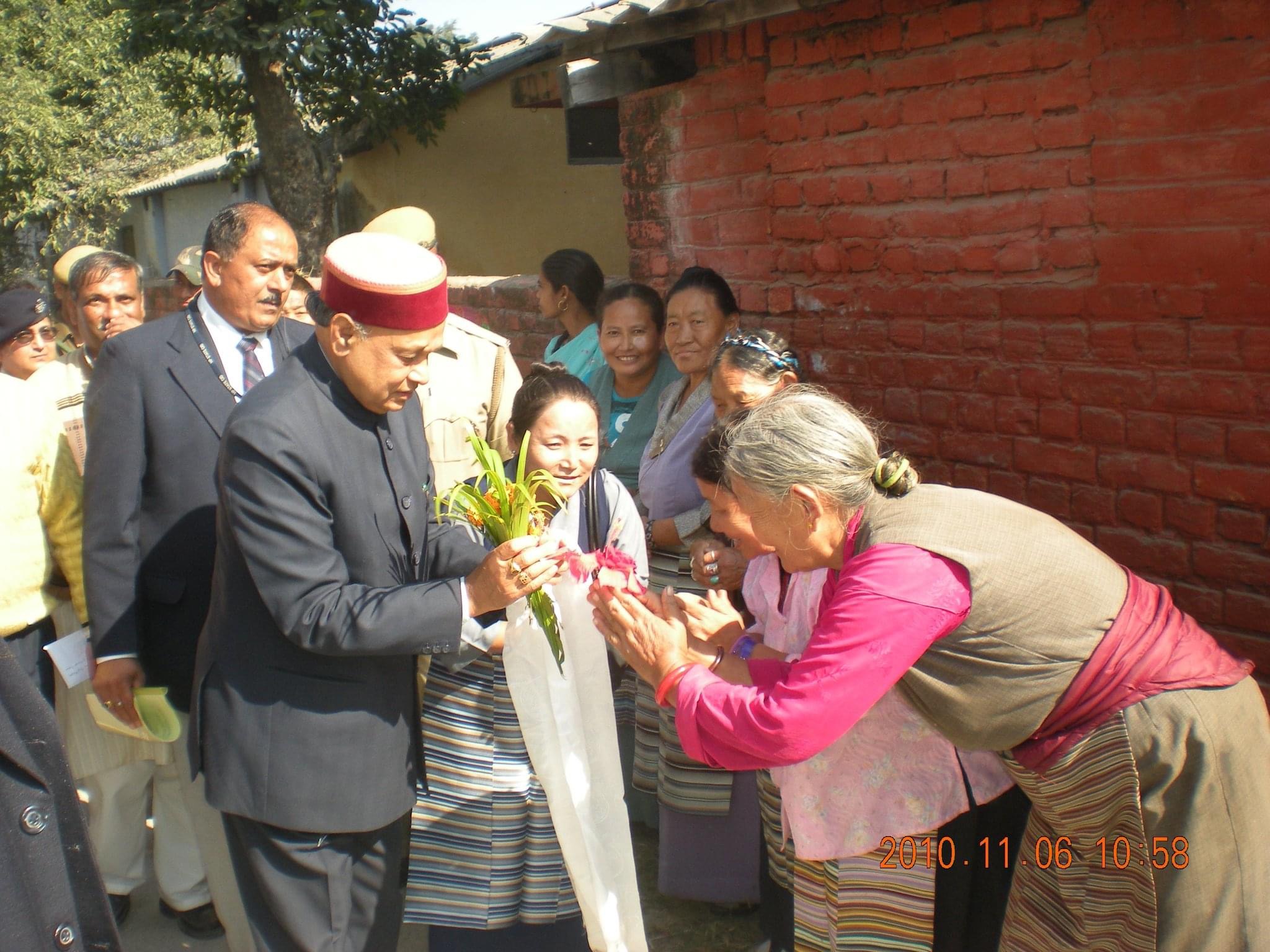 Mrs. Karma Dolma receiving (then) HP Chief Minister Shri Prem Kumar Dhumal upon his arrival at Poanta Cholsum Tibetan Settlement in the year 2010. 