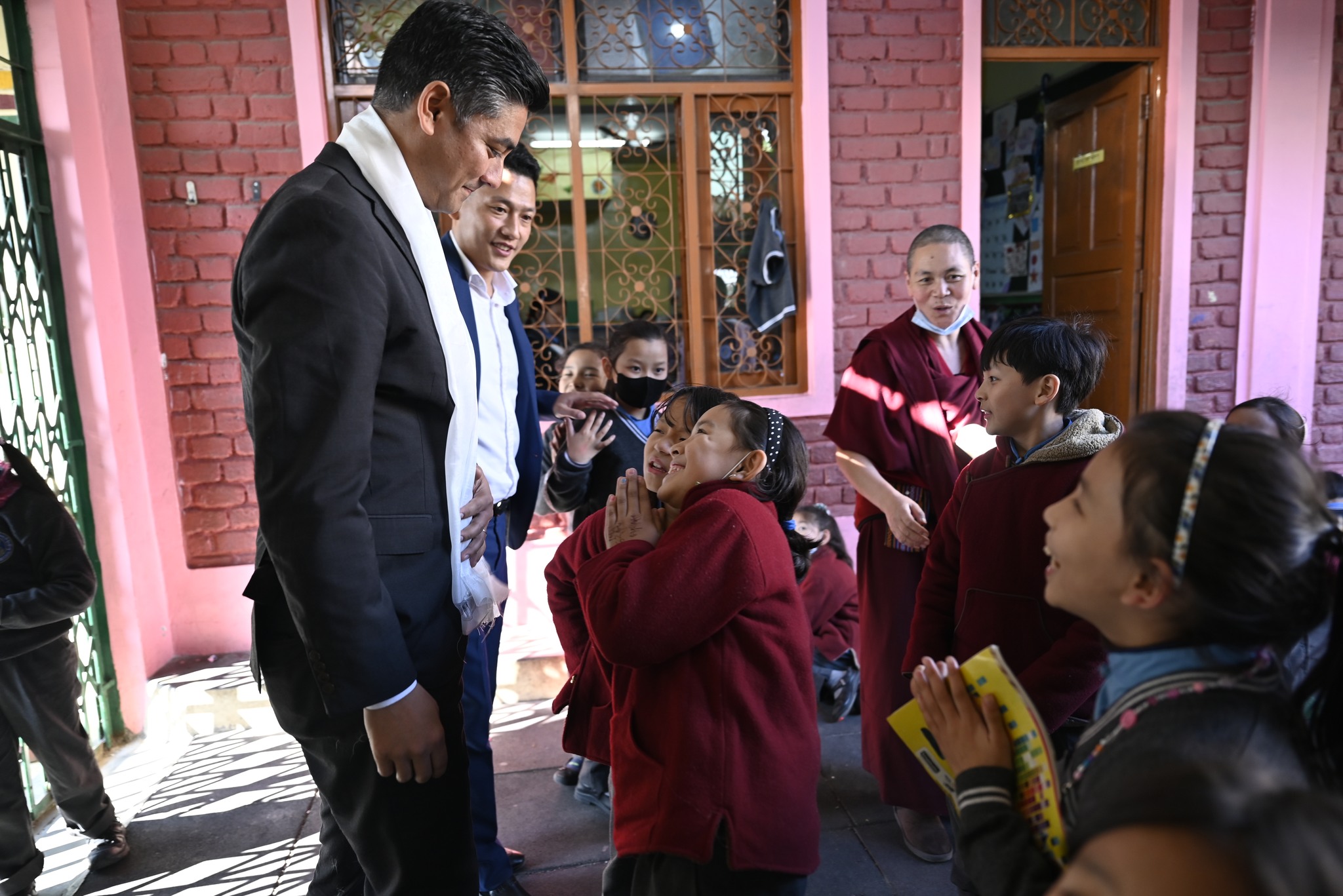 Cincinnati Mayor Aftab Karma Singh Pureval is being greeted by students of Petoen school. Photo | Tenzin Jigme | CTA 